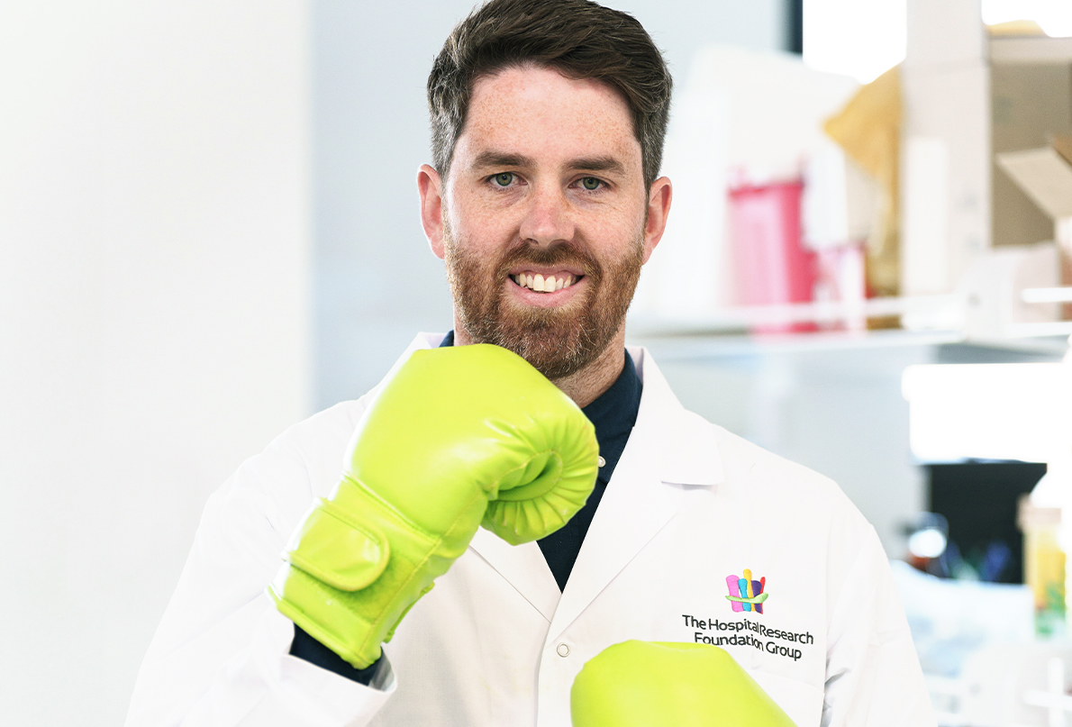 Researcher with bright lime green boxing gloves